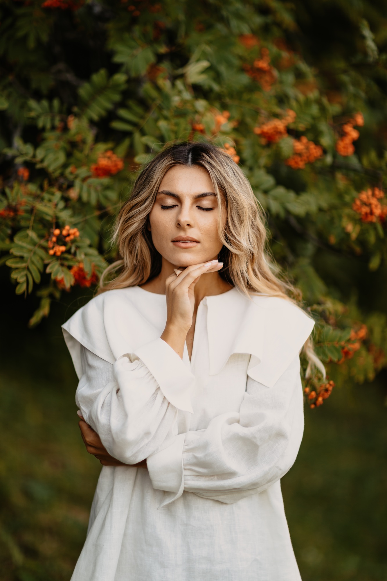 Beautiful young woman with smooth tanned skin laughed cheerfully while standing against background